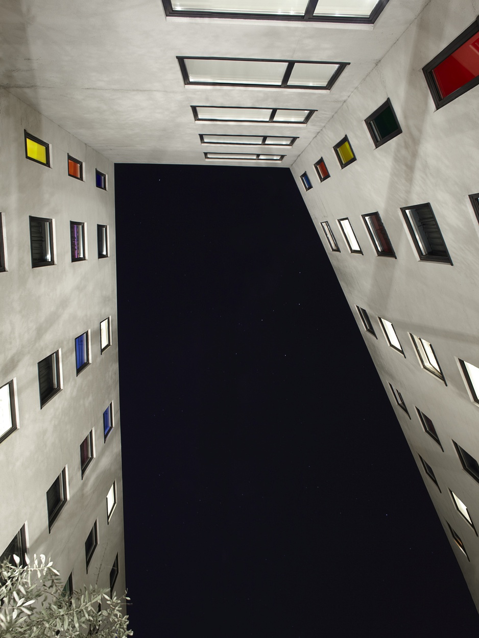 The Hoxton, Shoreditch hotel facade looking up to the dark sky