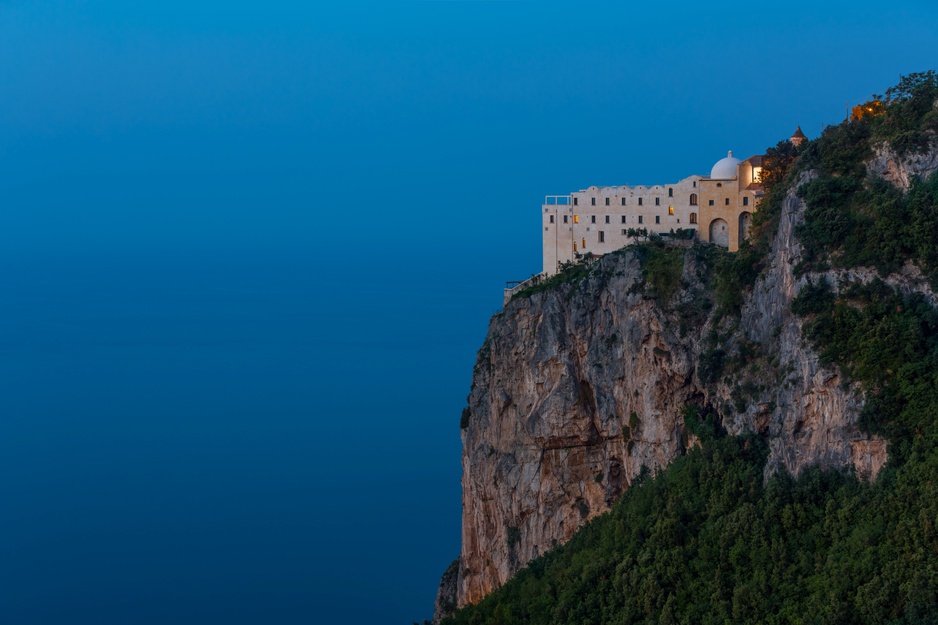 The Monastero Santa Rosa Hotel & Spa Exterior at Dawn Above the Cliff