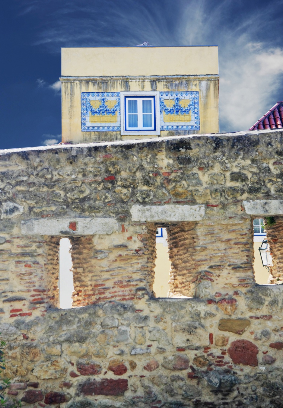 Walls of the St. Jorge's Castle with view on Solar do Castelo hotel