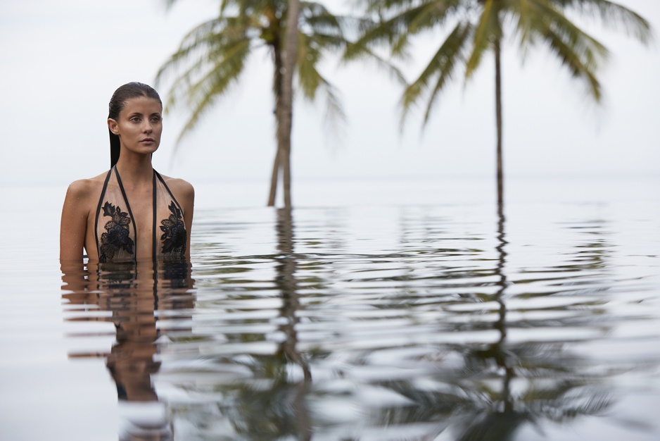 Model girl in bikini in the infinity pool