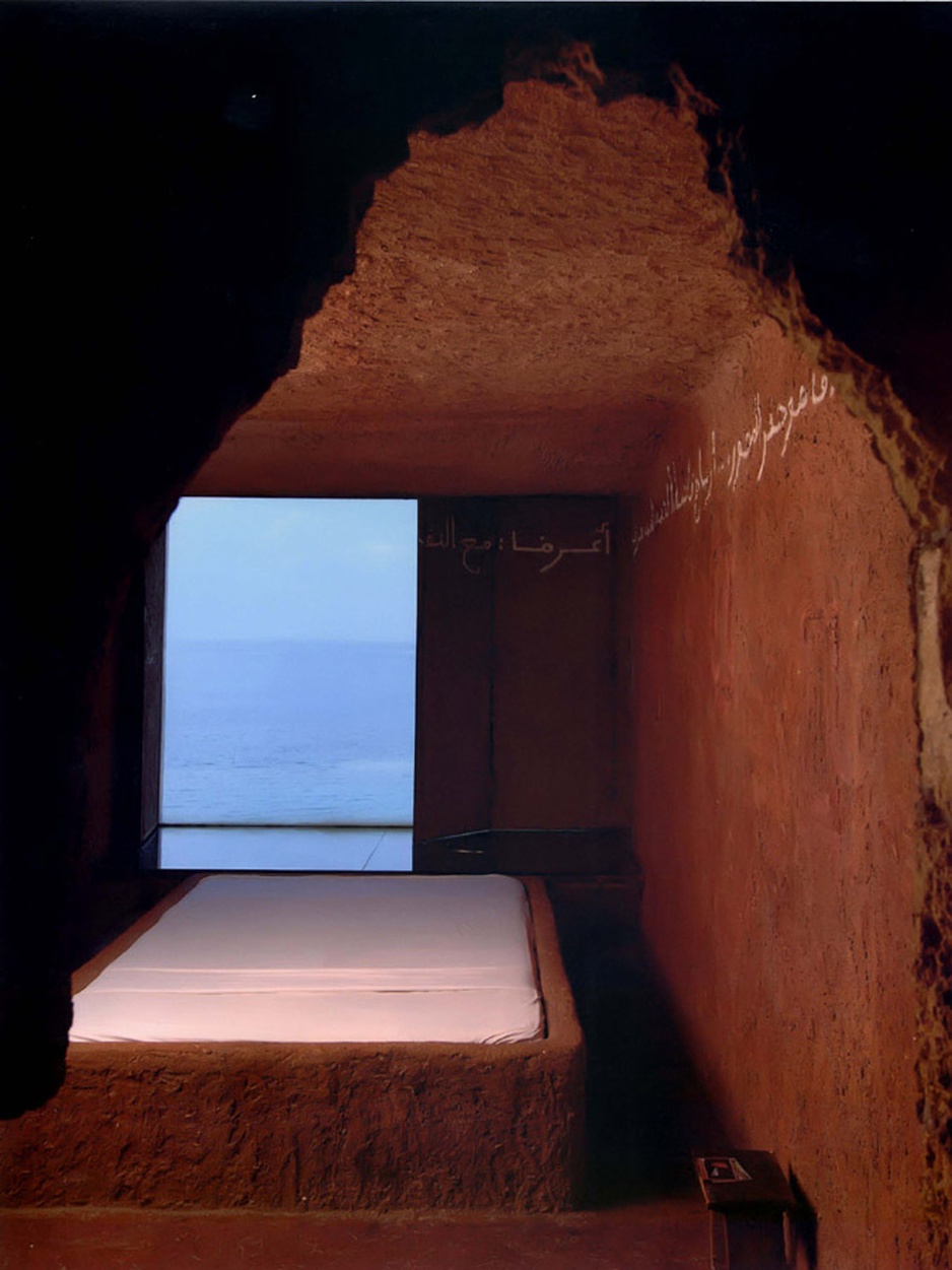 Arabic script on the wall and sea view from the room