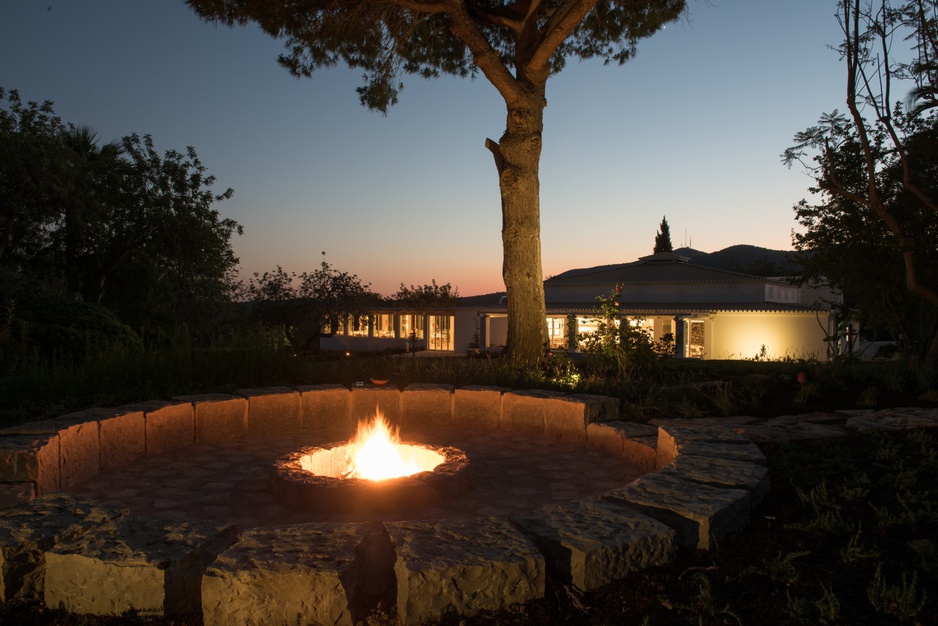 Vila Monte garden fireplace at night