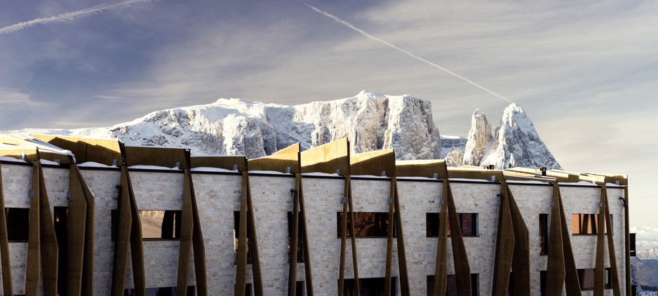 Alpina Dolomites hotel facade with rock formations of the mountains the background