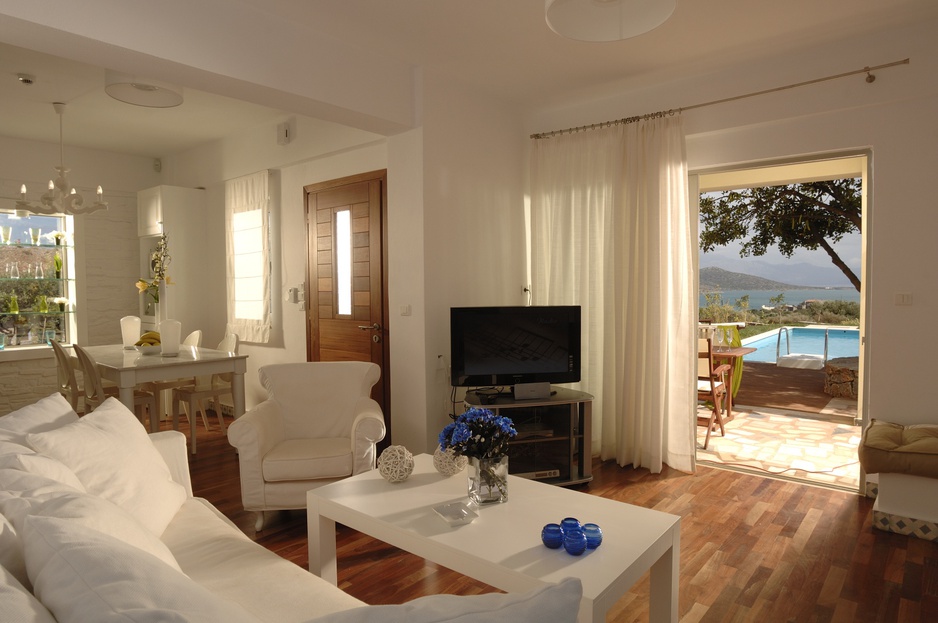 Domes of Elounda living room with private balcony and pool