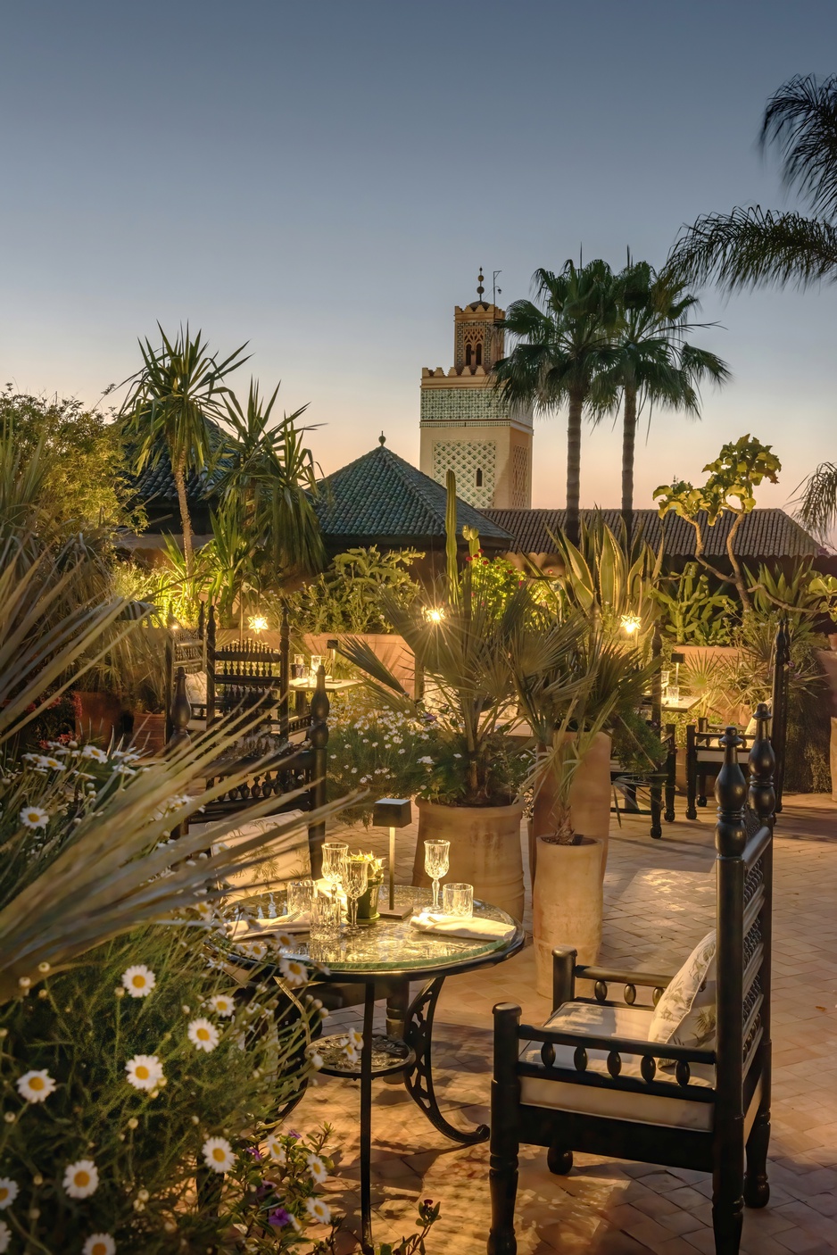 La Sultana Hotel Rooftop Terrace At Night With View Of A Minaret