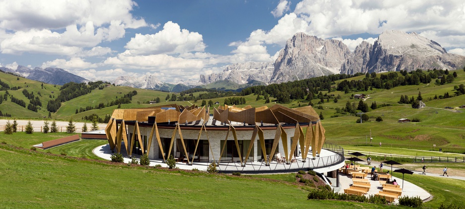 Alpina Dolomites hotel with garden and mountains around