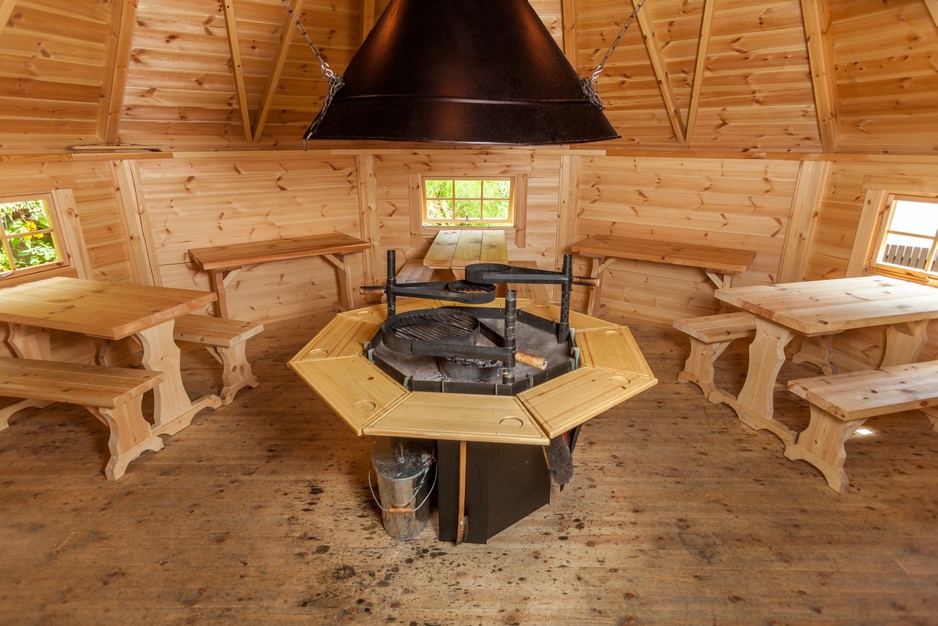 Wooden hut with fireplace in the middle to cook