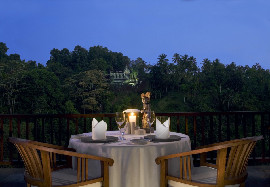 Candelit dinner with temple in background at Hanging Gardens Ubud