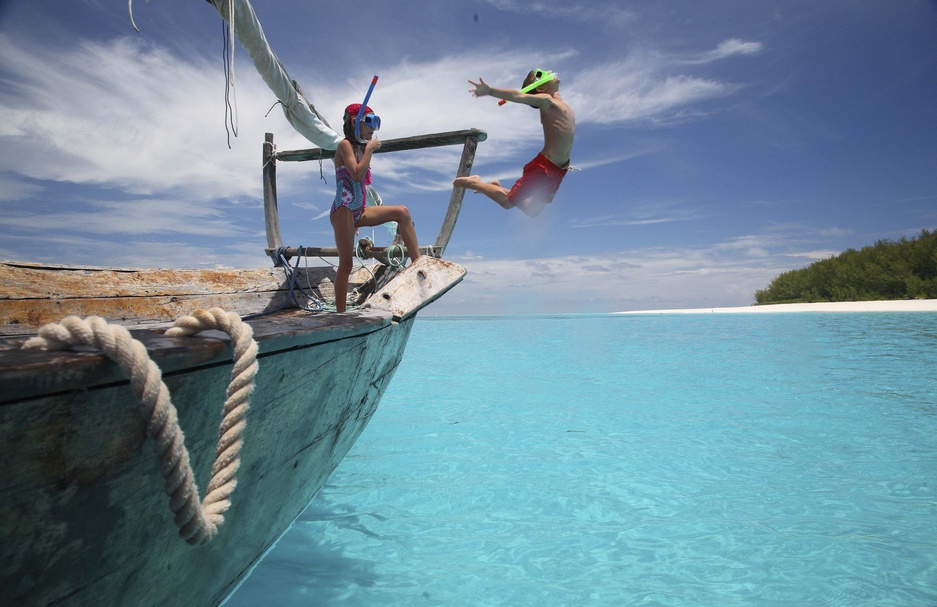 andBeyond Mnemba Island kids jumping from the boat