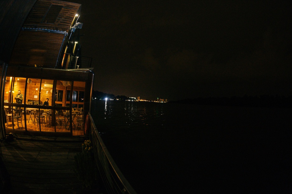 ArkaBarka Floating Hostel at night with river Danube