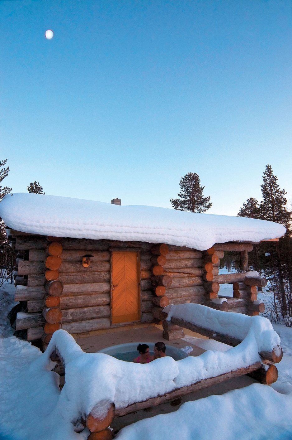 Wooden house with jakuzzi in the winter