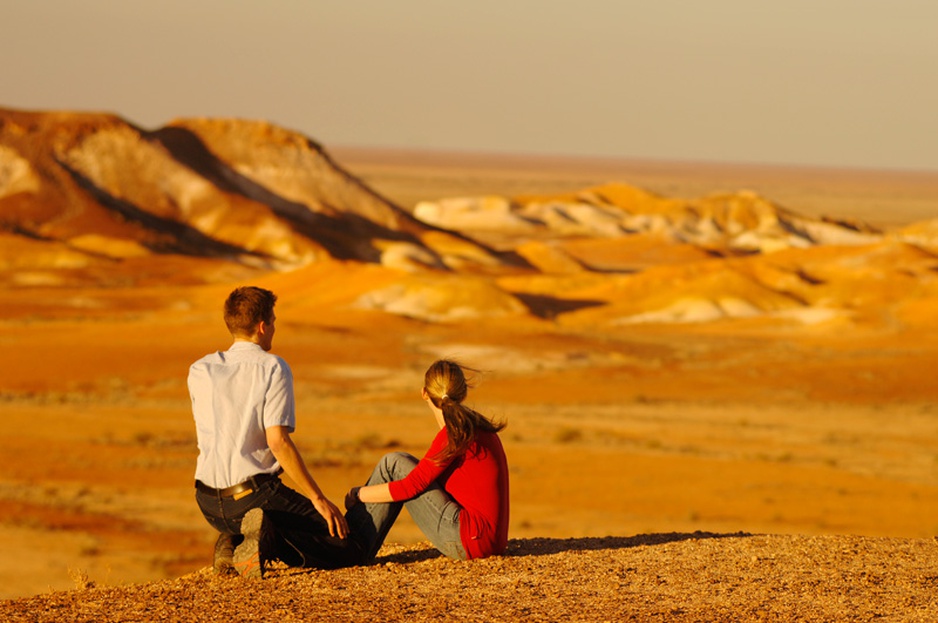 Couple sitting in the desert next to Coober Pedy in Australia