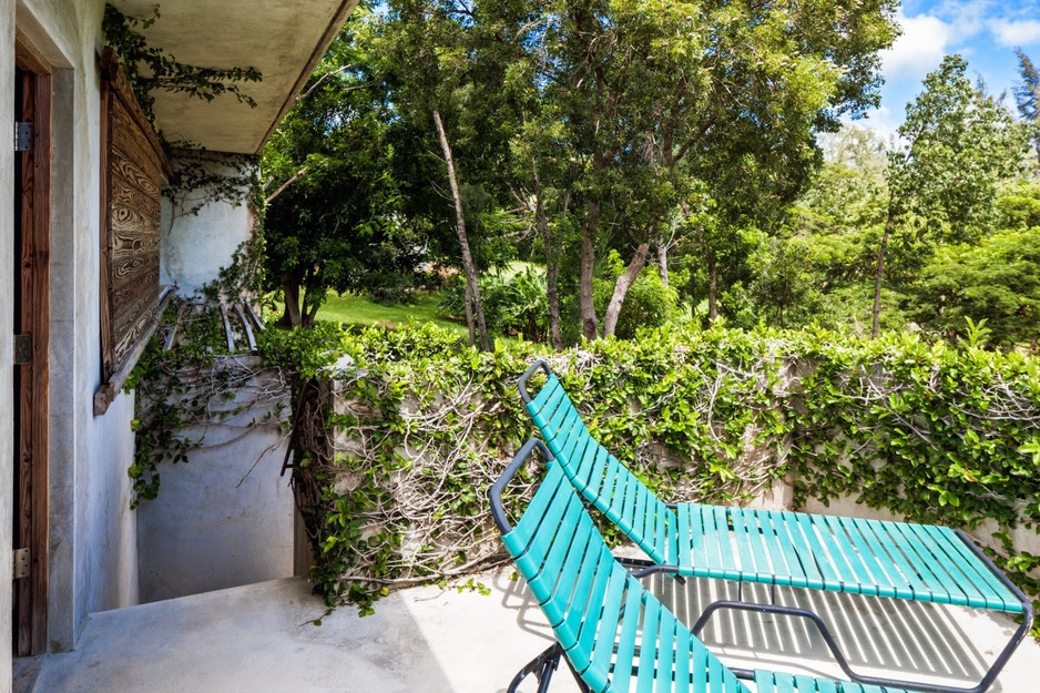 Triangular house terrace with blue chairs