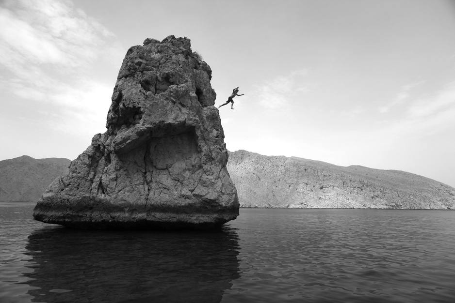 Jumping from the rocks in Zighy Bay