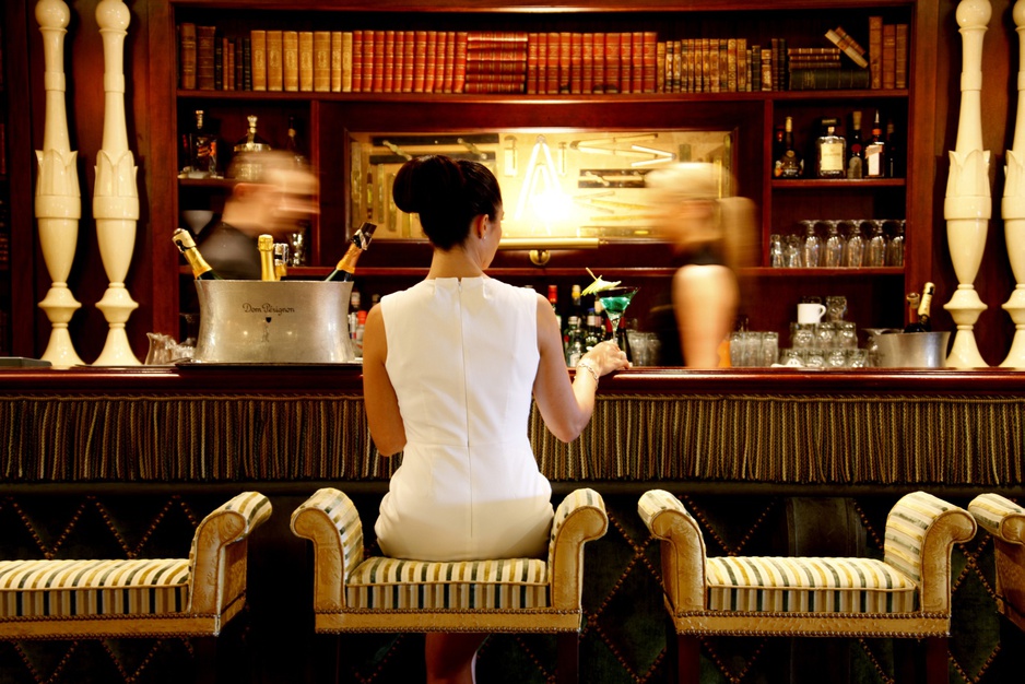 Hotel Metropole bar with a young lady in white dress