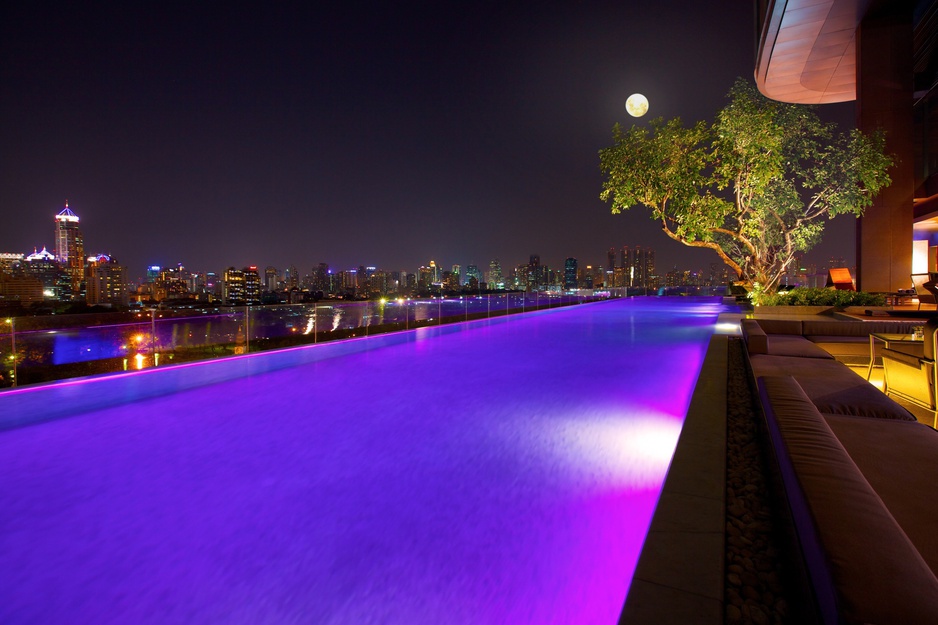 Infinity Pool at night with purple lights