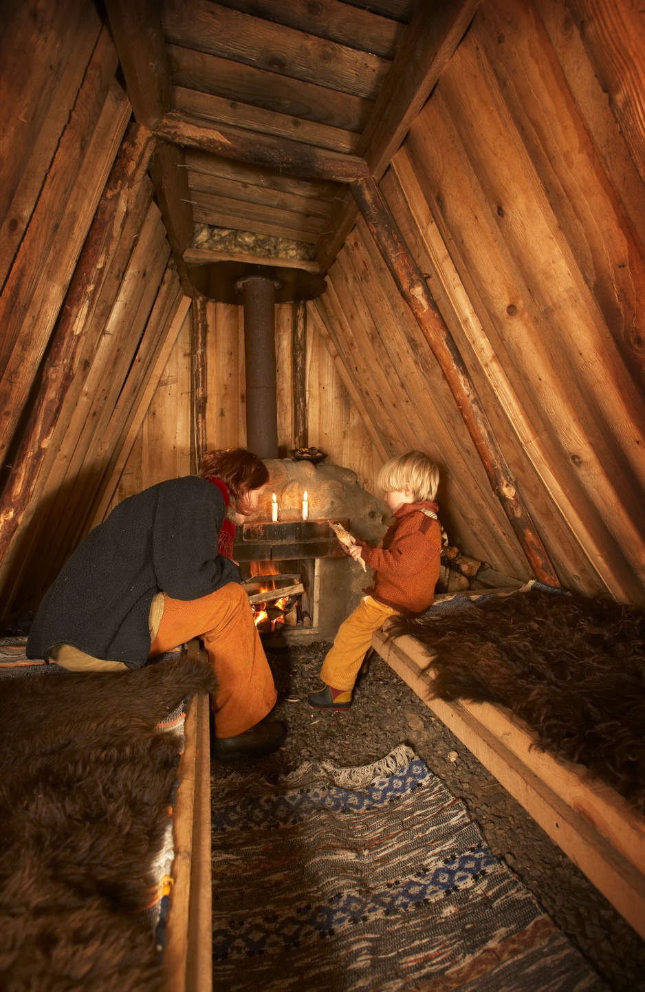 Mother and son at the firplace in the hut