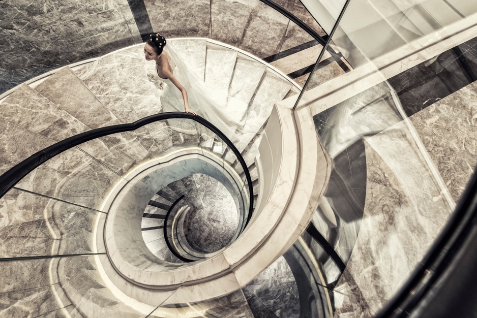 Regent Shanghai Pudong circle staircase with a woman in wedding dress