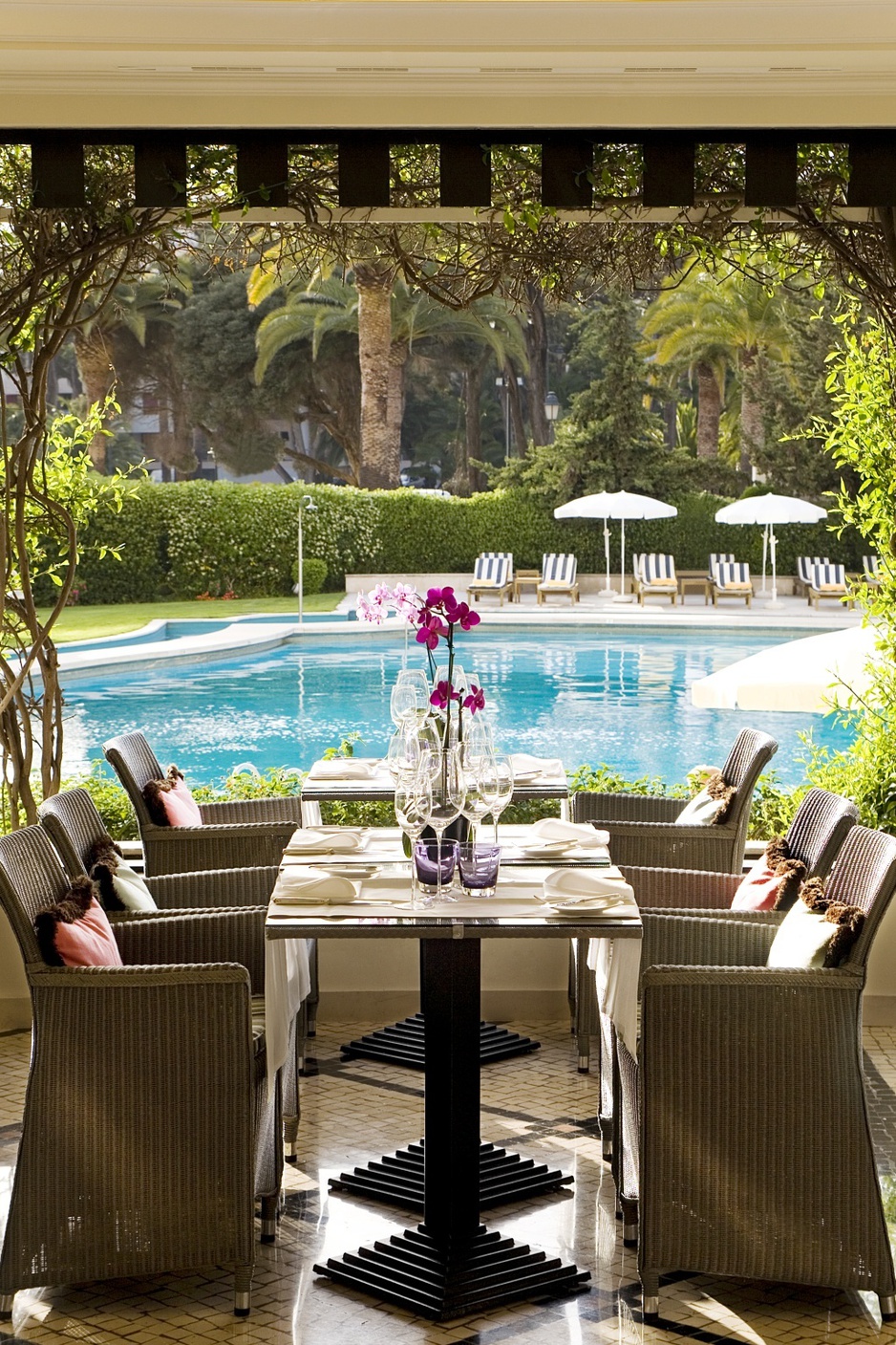 View from the inside of Hotel Palacio Estoril to the swimming pool through the glass window