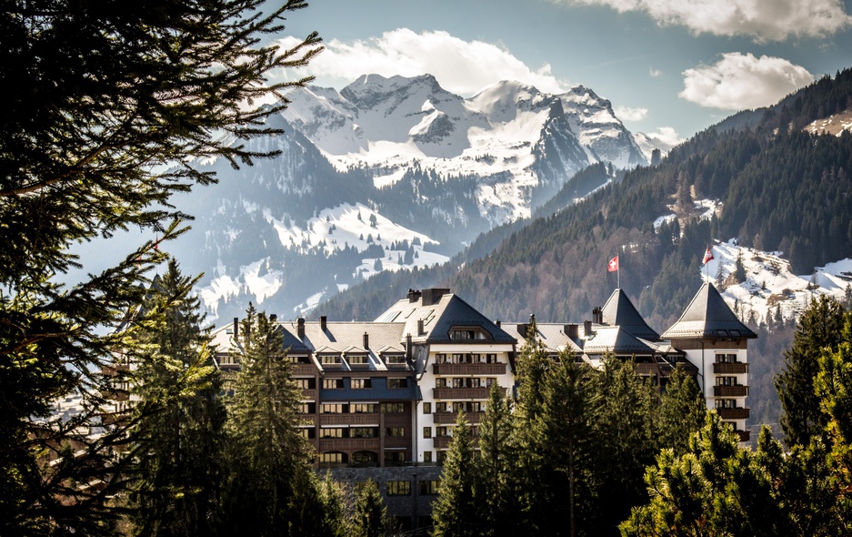 Alpina Gstaad Hotel with Snowy Alps in the Background