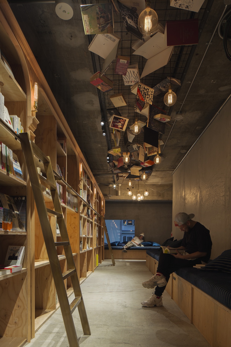 Book and Bed Tokyo free wifi in use, and the bookshelves