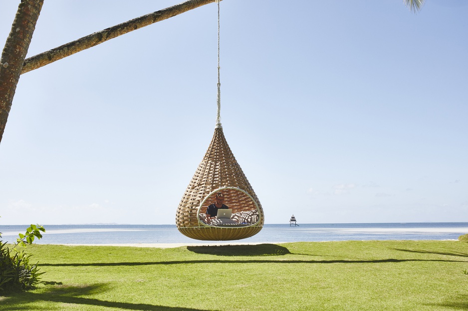 Swinging chair from palm tree on the beach