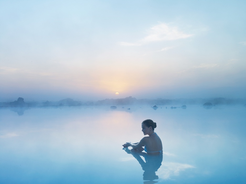 Beautiful woman enjoying the Blue Lagoon in Iceland