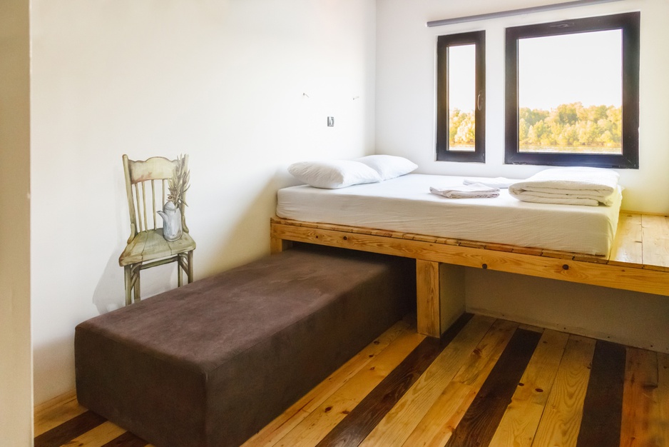 ArkaBarka Floating Hostel room with wooden platform for bed