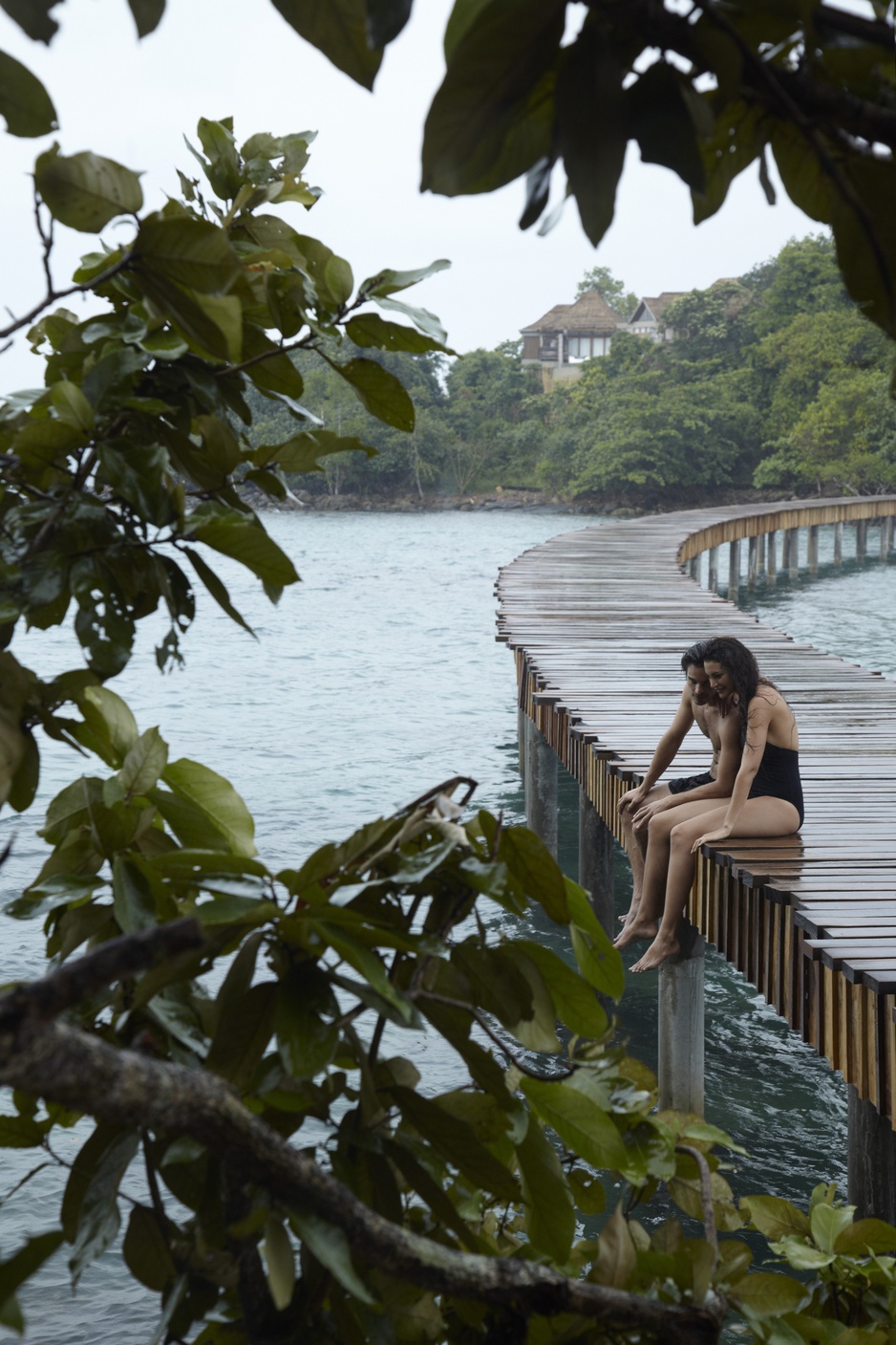 Guest couple sitting in the rain on the bridge to Koh Bong